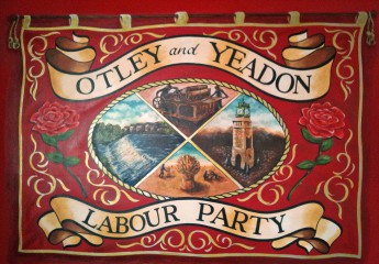 Mural of Otley and Yeadon Labour Party branch banner. Includes images of the weir and clock tower at Otley, the Wharfedale printing press and a grain field at harvest time