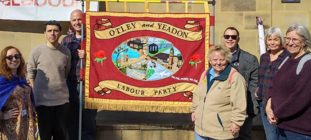 Nigel Gill with other Labour members including Alex Sobel MP holding the Otley and Yeadon Labour branch banner at a rally in Leeds
